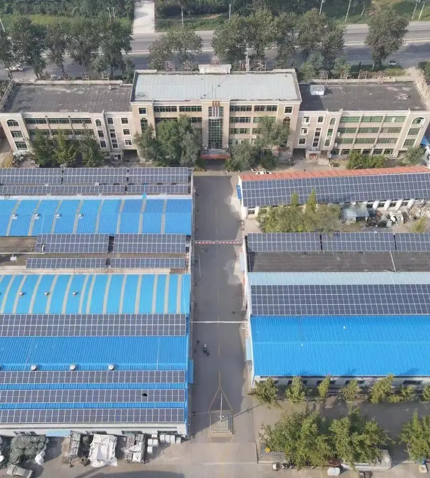 Aerial view of factory rooftops fitted with solar modules