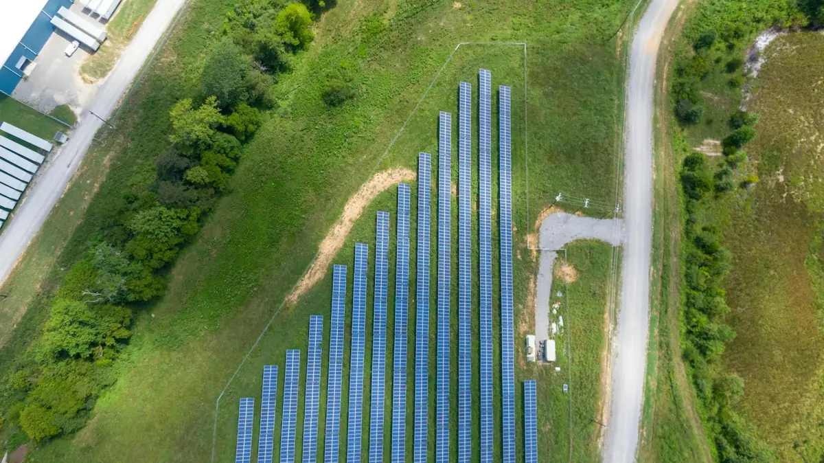 Aerial view of solar arrays installed on greenfield land